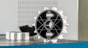 3D printed sprocket wheel shown on conveyor assembly, highlighting precision gear design and industrial application